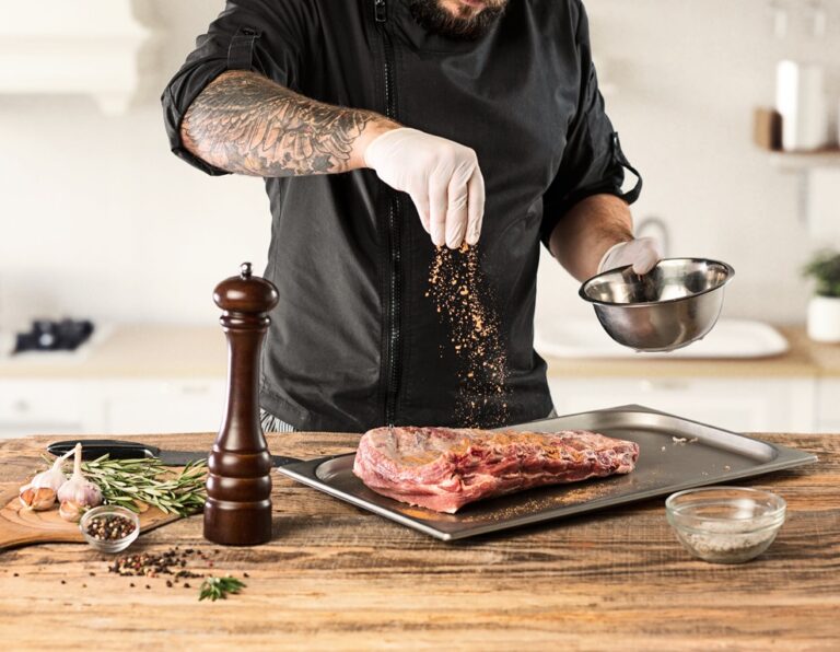 Man cooking meat steak on kitchen or home