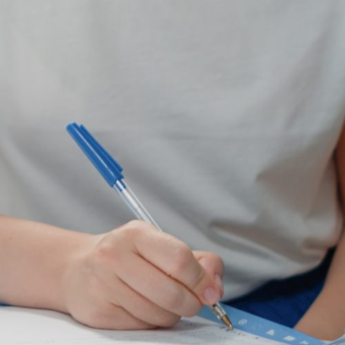 Close up of woman signing checkup documents for treatment from specialist. Medic asking for signature on prescription papers from sick patient at medical visit. Person and doctor with files