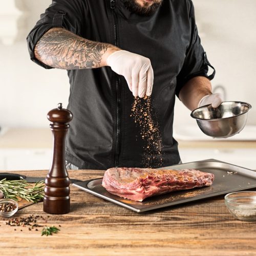 Man cooking meat steak on kitchen or home