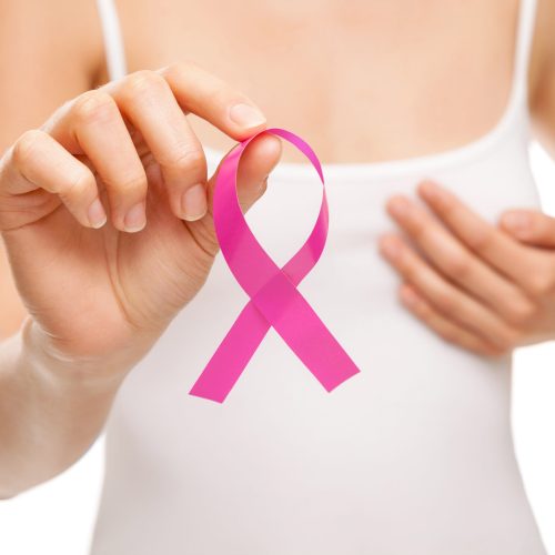 Woman with a pink breast cancer awareness ribbon